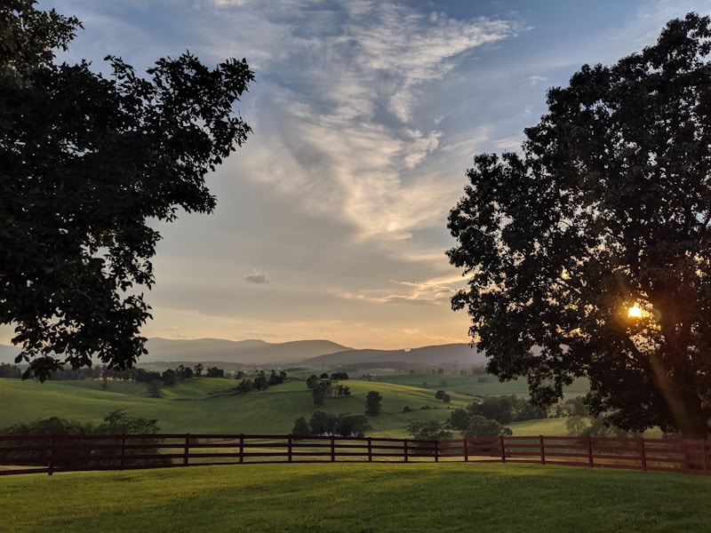 Rolling farmland in the Shenandoah Valley at sunset with the Blue Ridge in the distance